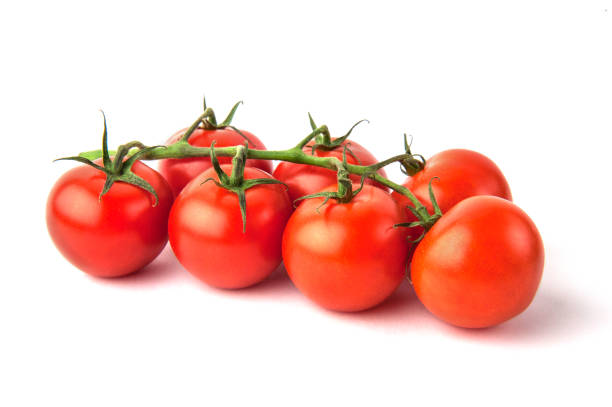 istock Branch of ripe cherry tomatoes isolated on white background 1227042920