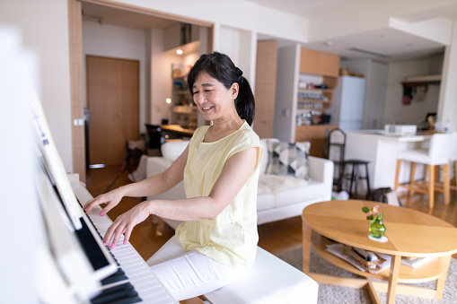 woman playing the piano at home