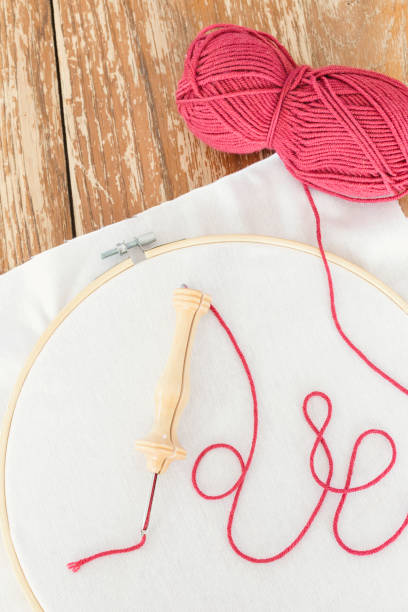 istock Punch needle pen with colorful pink yarn ready to start a handmade project. 1227043767