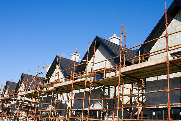 istock row of houses roofs with scuffolds 122704464