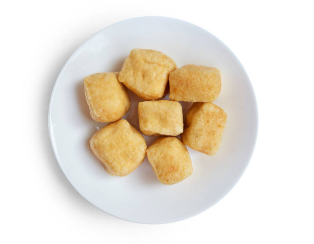 Group of brown tofu puff with plate isolated on white.