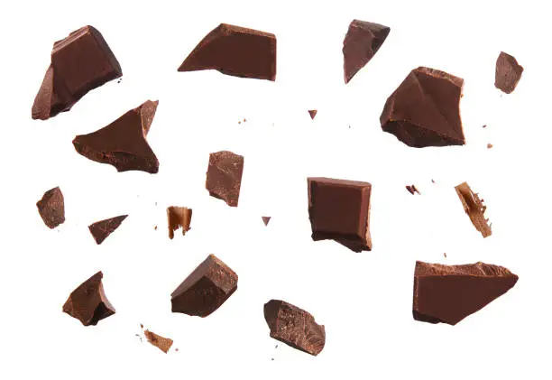 Photo of Cracked chocolate parts from top view isolated on white background