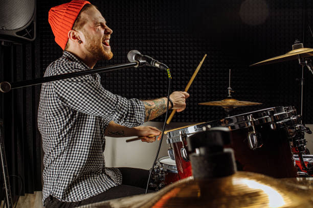 istock young man play on drums and sing 1227052199