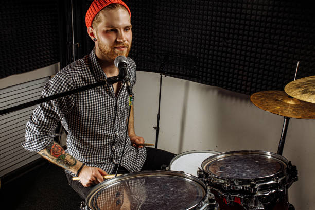 istock talented musician preparing to play on drums and sing 1227052202