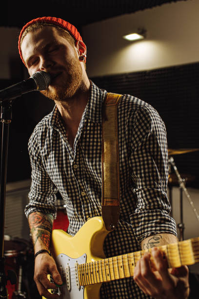 istock awesome musician play electric guitar and sing 1227052222