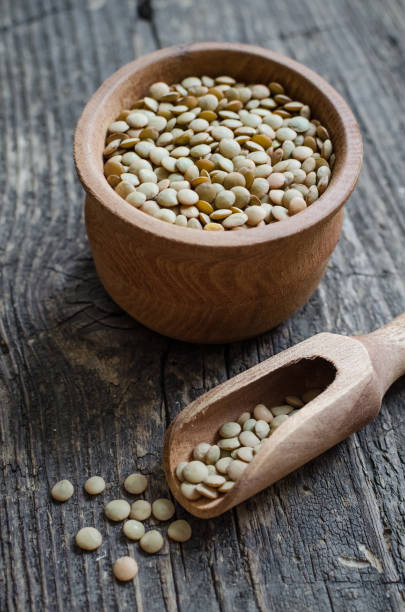 istock Brown dried lentils in a wooden bowl 1227052235