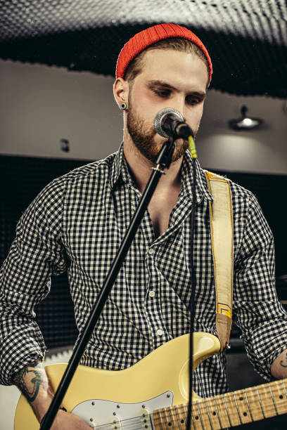 istock talented caucasian musician play guitar and sing 1227053454