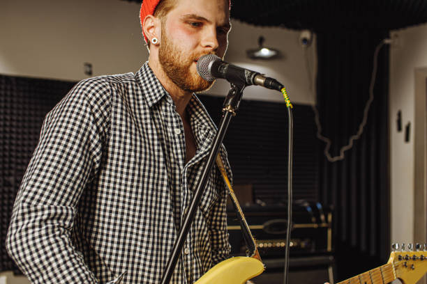 istock awesome musician play electric guitar and sing 1227053464