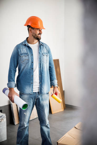 istock Happy young man in helmet decorating flat 1227054368