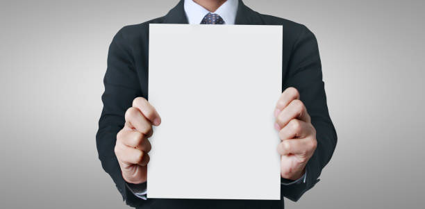 istock Close up hand holding paper blank for letter paper 1227054411