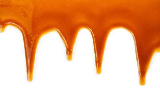 istock Background of flowing caramel sauce isolated on white. 1227057297