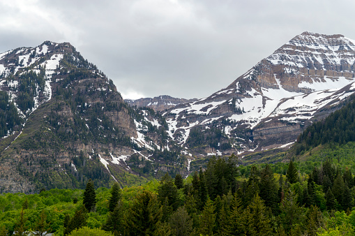 This is a panoramic shot showing Mount Timpanogos in Utah's Wasatch Mountains range.  Mt. Timpanogos is a tall landmark in Utah County, ajoining many of the cities including Provo.  This shot was taken during the late spring from near the Sundance Mountain Resort area.