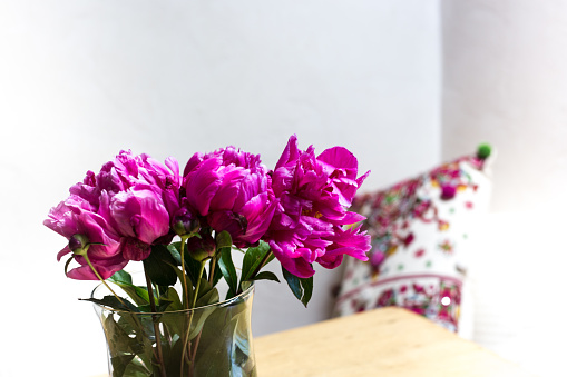 Cut Peonies on Wood Table, Throw Pillow, White Wall