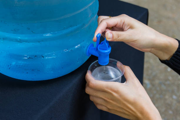 istock Female hand holding water glass 1227063232