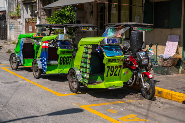 Tricycles waiting at a street for people wanting delivery services Tricycles waiting at a street for people wanting delivery services. These vehicles are a form of basic local transportation common in the Philippines philippines tricycle stock pictures, royalty-free photos & images