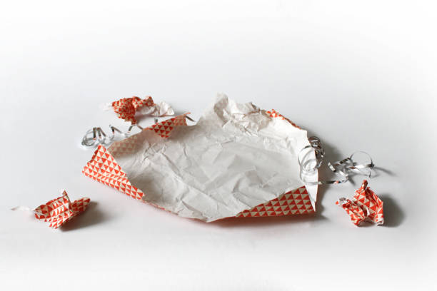 istock Unwrapped Crumpled Gift Wrap Red Isolated on White 1227067082