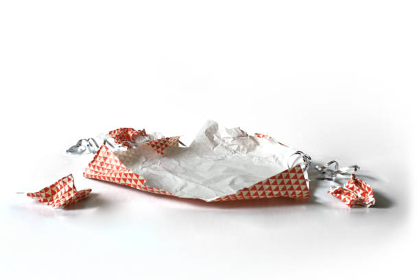 istock Unwrapped Crumpled Gift Wrap Red Isolated on White 1227067084