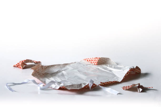istock Unwrapped Crumpled Gift Wrap Red Isolated on White 1227067103