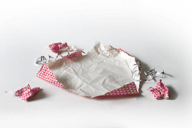 istock Unwrapped Crumpled Gift Wrap Pink Isolated on White 1227068078