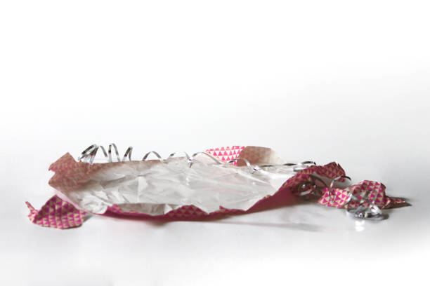 istock Unwrapped Crumpled Gift Wrap Pink Isolated on White 1227068079