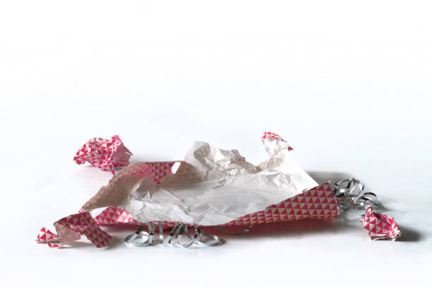 istock Unwrapped Crumpled Gift Wrap Pink Isolated on White 1227068084