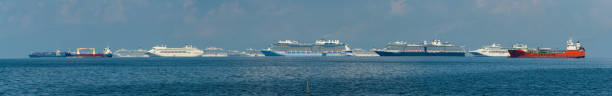 luxury transportation, large cruise ship docked at pier in dark sea, cinematic process aerial top view