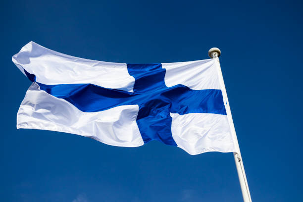 istock Finnish national flag on the wind against the blue sky 1227078169