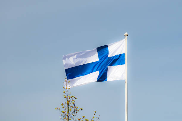 istock Finnish national flag on the wind against the blue sky 1227078183