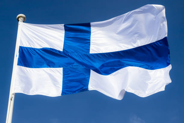 istock Finnish national flag on the wind against the blue sky 1227078194
