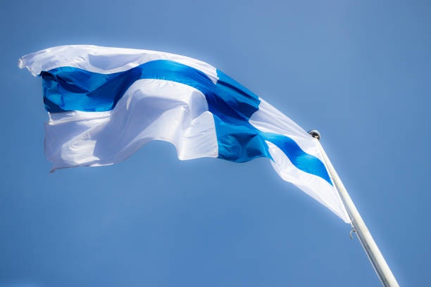 istock Finnish national flag on the wind against the blue sky 1227078205
