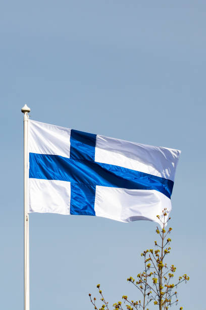 istock Finnish national flag on the wind against the blue sky 1227078216
