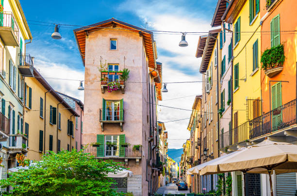 istock Traditional colorful building with balconies, shutter windows and multicolored walls in typical italian street, Brescia city historical centre, blue sky background, Lombardy, Northern Italy 1227078539