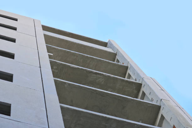 a panel house under construction against the blue sky. bottom-up shooting. - social housing audio imagens e fotografias de stock