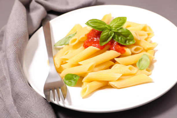 Unrecognizable woman eating pasta with shrimps for lunch