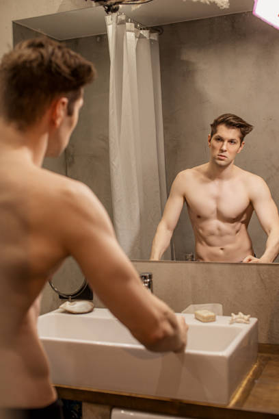 istock man after shower, look at mirror 1227082293