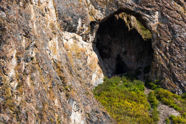 istock small cave or grotto in mountain cliff, mountaineering and caving in rocks 1227083327