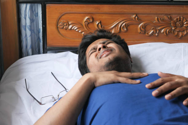 istock Man having heart attack on bed, chest pain 1227083940