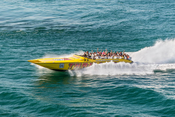Tourists enjoying a high speed sightseeing boat tour of Miami and Miami Beach Miami, FL, United States - April 28, 2019: Tourists enjoying a high speed sightseeing tour of Miami and Miami Beach in a power boat in Miami, USA. racing boat photos stock pictures, royalty-free photos & images