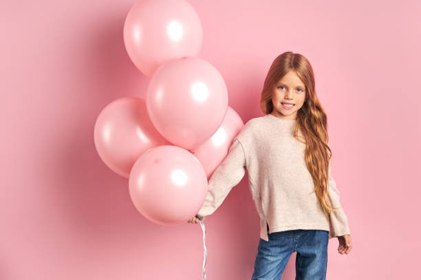 istock Smiling caucasian kid posing with air balloons 1227086803