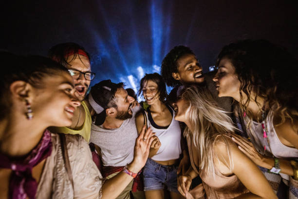 istock Large group of cheerful people having fun on a night party. 1227088077