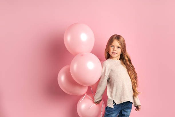 istock Smiling caucasian kid posing with air balloons 1227088280