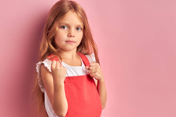 istock Cute little girl kid posing look at camera isolated 1227088992