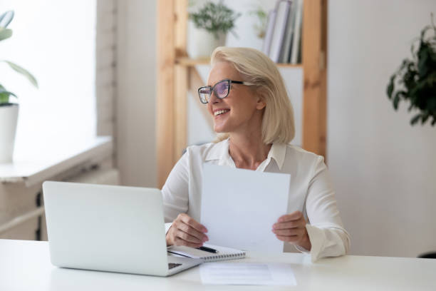 Smiling senior woman look in distance thinking