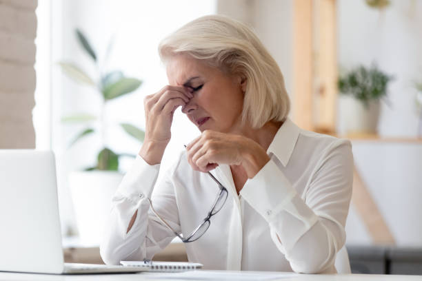 istock Exhausted mature employee suffer from migraine at workplace 1227089112