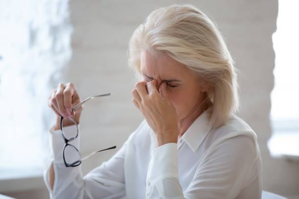 istock Tired middle-aged woman suffer from headache in office 1227089113