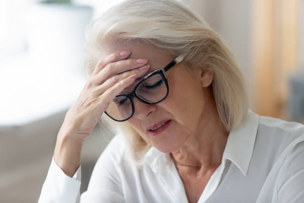 istock Unhealthy mature female suffer from headache at workplace 1227089126
