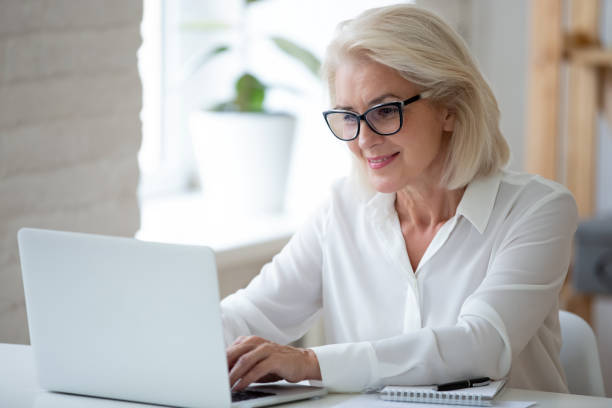 istock Focused middle-aged businesswoman work on laptop in office 1227089128