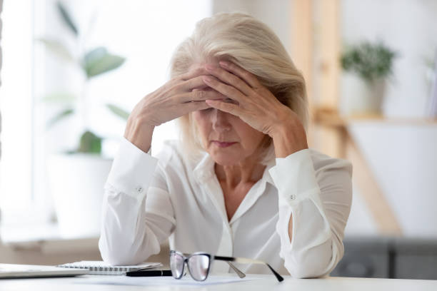 istock Frustrated mature female employee feel distressed at workplace 1227089136