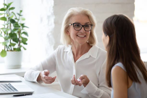 istock Happy diverse female colleague brainstorm using laptop 1227089139