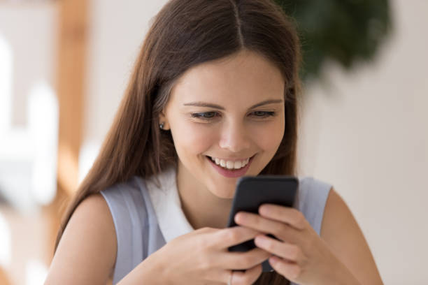 istock Happy young woman using wireless internet on smartphone gadget 1227089178